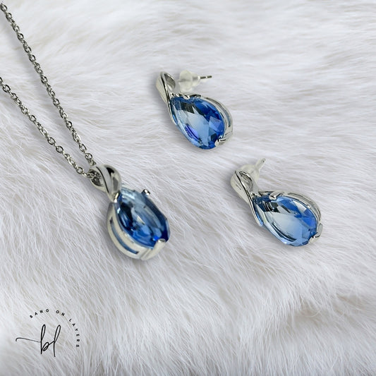 Rhodium Plated CZ Studded Pendant & Earrings Set In Blue & White Colour
